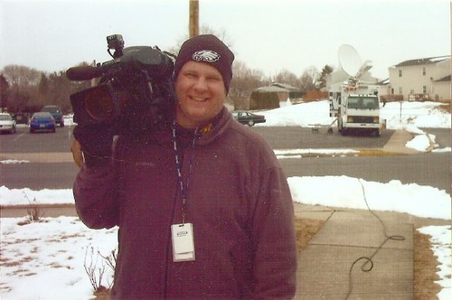 carrying a camera in front of abc27's satellite truck